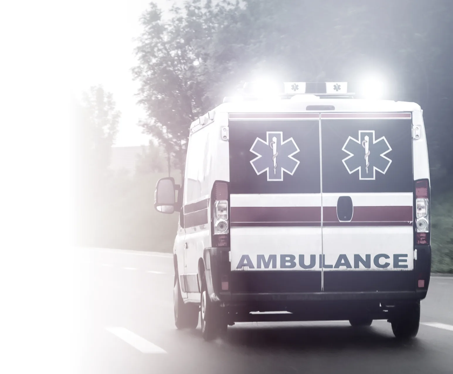 An ambulance responding on a highway
